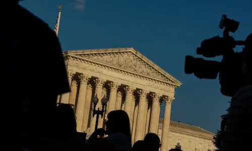 Supreme Court Building in Washington DC with TV camera black Silhouettes in foreground